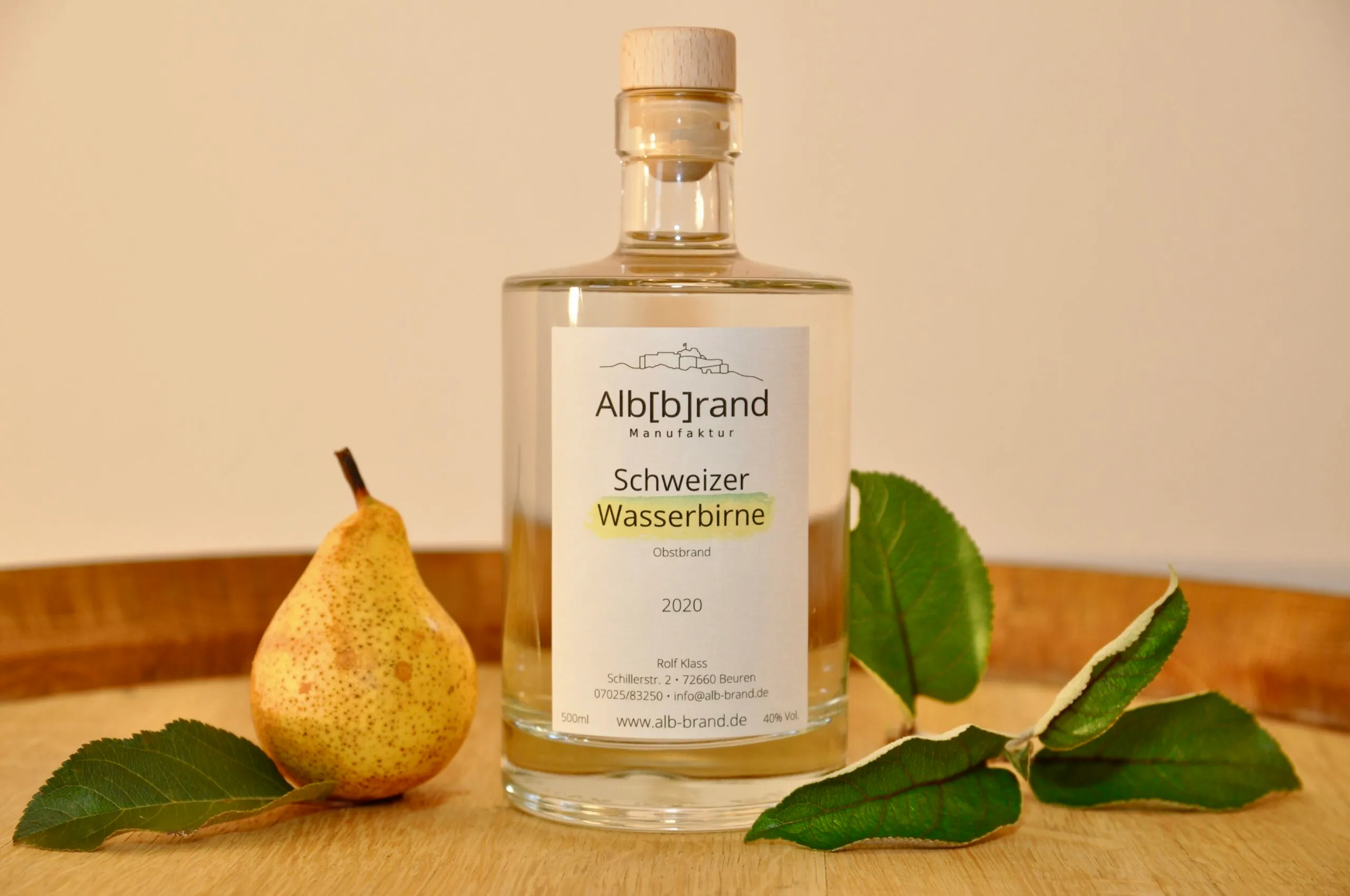 Flasche Birnenbrand Schweizer Wasserbirne mit Birne auf einem Holzfass